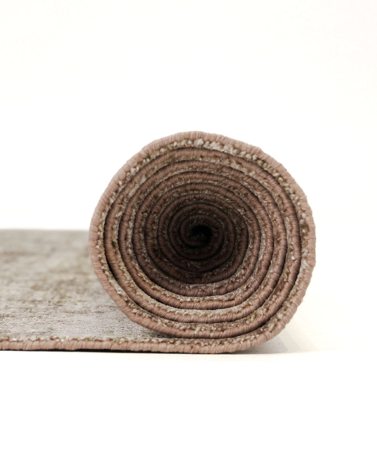 A RAMSHA HOME Hand Knotted Living Room Rug (HKWB-013) in beige and brown with a modern distressed design is tightly rolled up on a white background, with one end facing the camera to showcase the spiral pattern of the fabric.