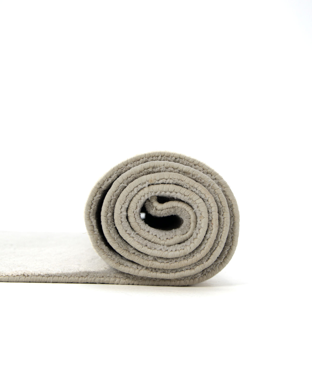 A rolled-up grey area rug from RAMSHA HOME is shown on a white background, with the rolled end facing the camera and the remainder of the rug extending out of frame to the left. The Decorative Rectangle Handmade Grey Color 200x300 cm Area Rug (LKH-039) features subtle geometric neutral patterns, adding understated elegance to any space.