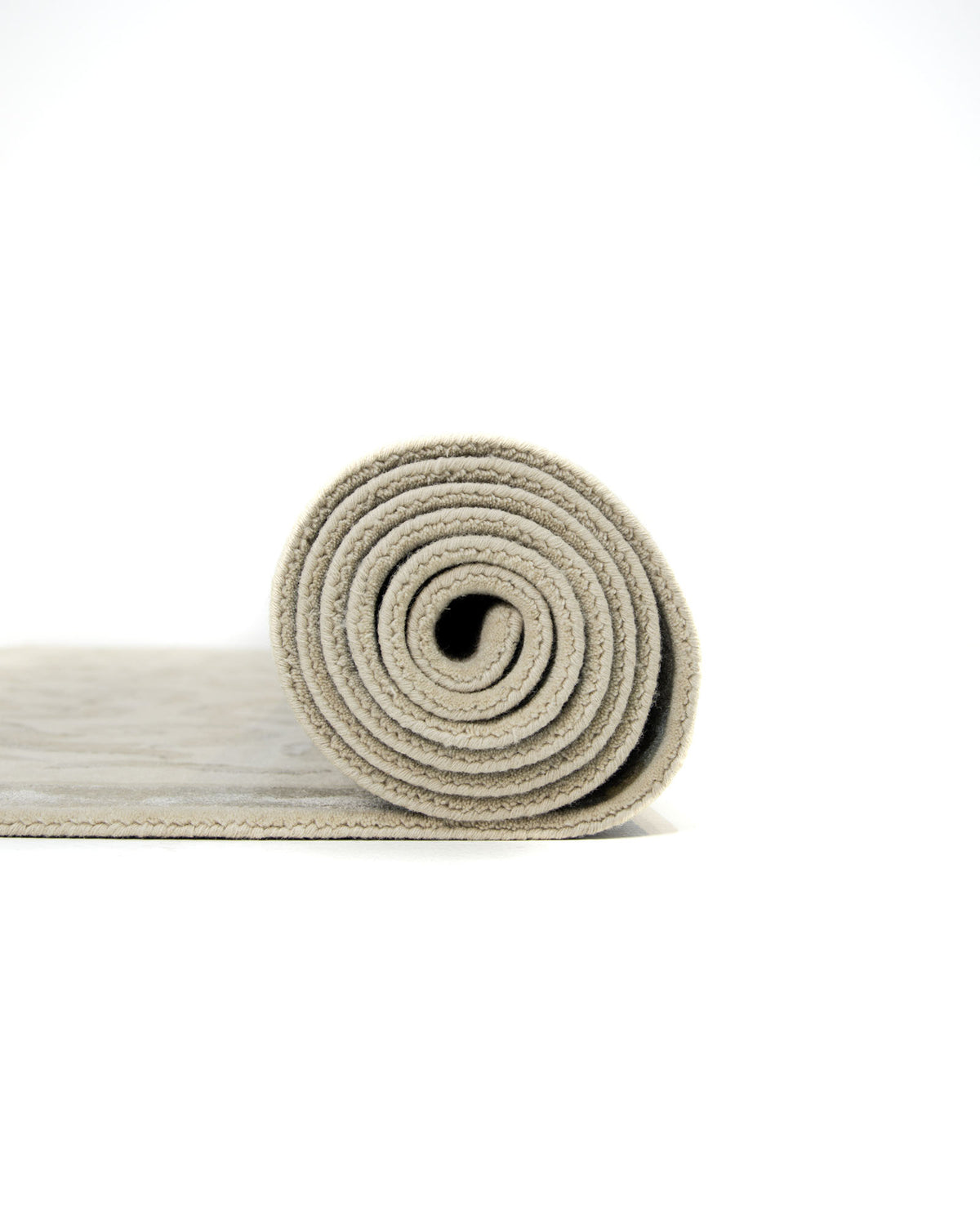 A rolled-up Amazing Multi Color Modern Floor Rug - HTWV 57 (300x400cm) by RAMSHA HOME is placed on a white surface against a plain white background, evoking the simplicity and elegance of a traditional medallion rug.