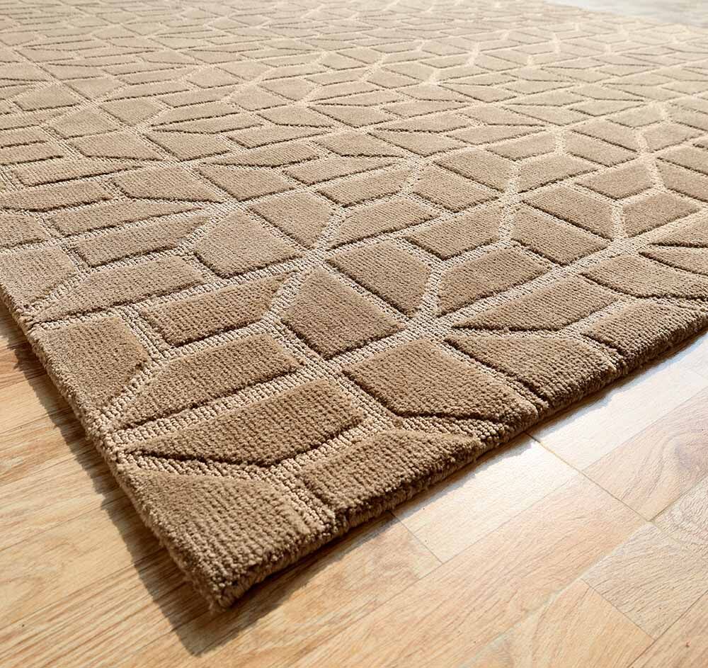 The RAMSHA HOME Drawing Room Decor Novara Rug - CMN 32 (200X290cm) features a taupe geometric raised pattern and adds textured interest on a light wood floor, viewed from one corner.