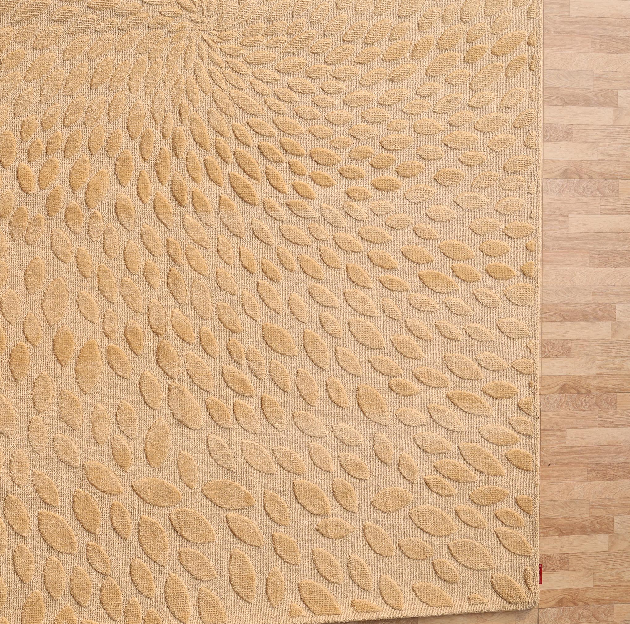 The RAMSHA HOME Modern Abstract 200x300 CM Rectangle Rug (CMN 107) in beige, with a raised leaf spiral pattern, brings subtle elegance to light wood floors.