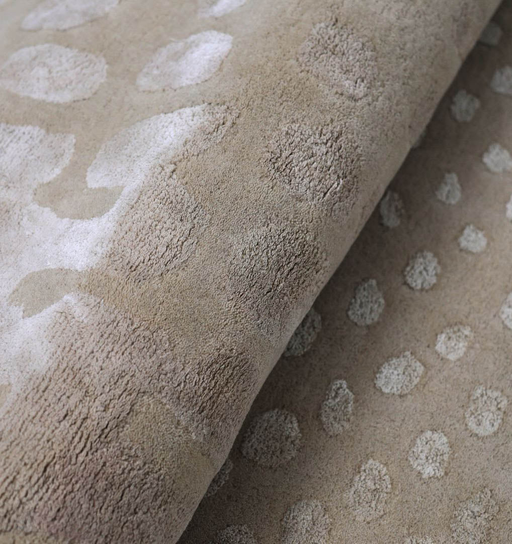 Close-up of RAMSHA HOME's Shape Floor Rug Multi Color HTWV 93 (200x300 cm): a hand-tufted beige rug featuring raised, irregular dot patterns and subtle color variations for a soft, velvety animal print effect.