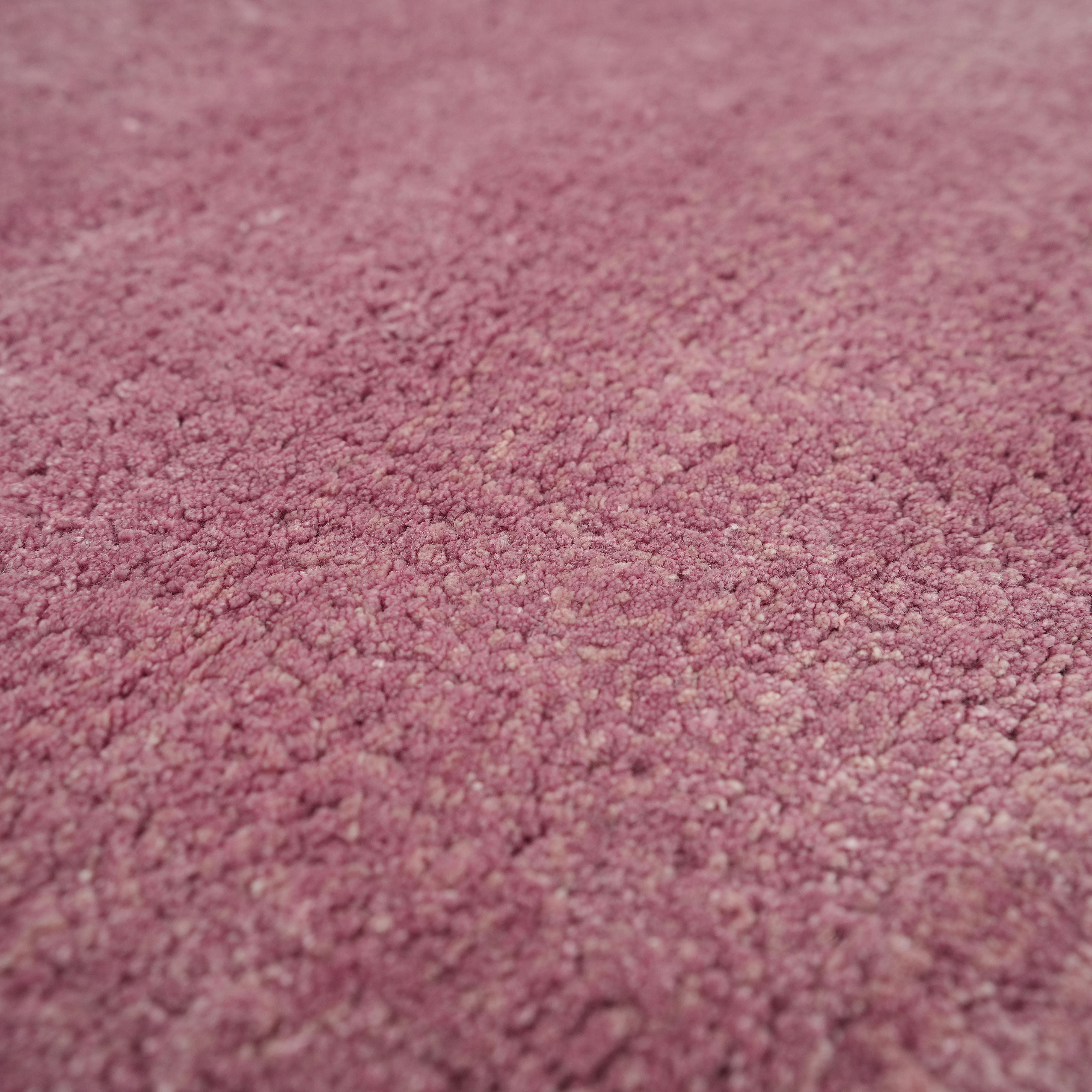 Close-up of the Rose Ombre Handmade Area Rug HTV 27 (300x400 cm) by RAMSHA HOME, highlighting its soft, textured pink Tencel cotton surface with detailed fibers and a plush, gently uneven finish.