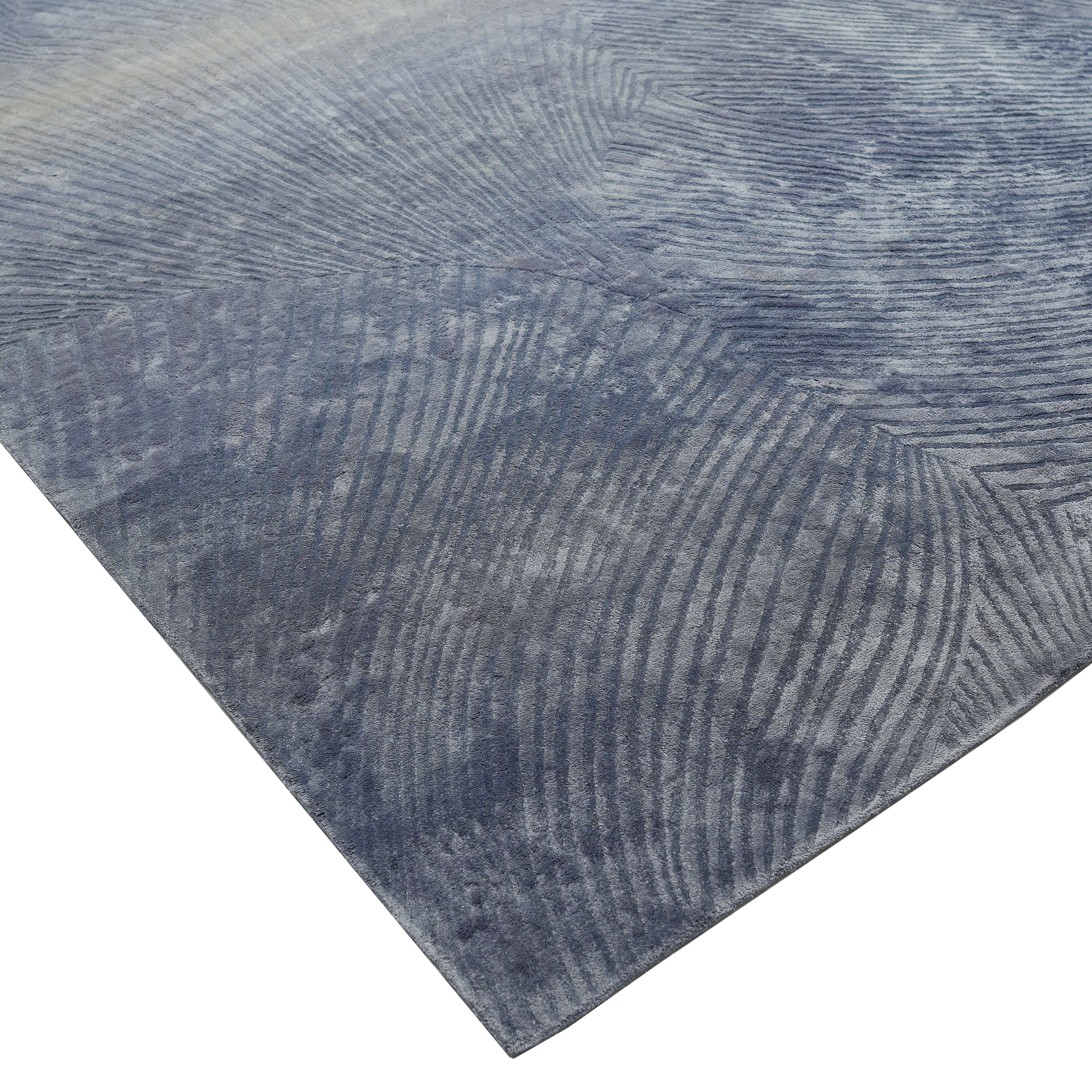 A close-up of the Blue Ginkgo Fan Handmade Rug HTV 29 (300x400 cm) by RAMSHA HOME shows its modern Scandinavian design in blue, with subtle overlapping curved and straight lines for a textured, abstract look.