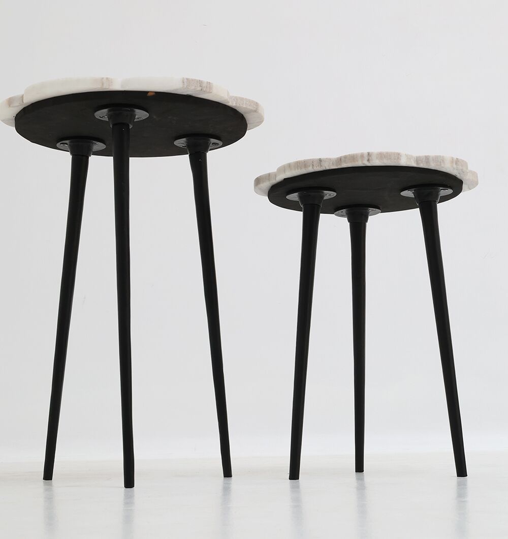 The RAMSHA HOME CloudForm Nesting Marble Tables feature a modern white marble design with black tapered legs. Set against a plain background, the larger table nests over the smaller one, perfect for stylish living room decor.