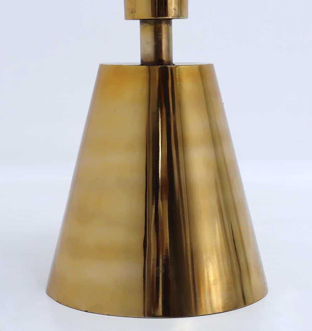 A close-up of the Aurelia Luxe Marble & Iron Accent Table by RAMSHA HOME features a shiny, metallic gold lamp base atop the modern table, set against a plain white background.