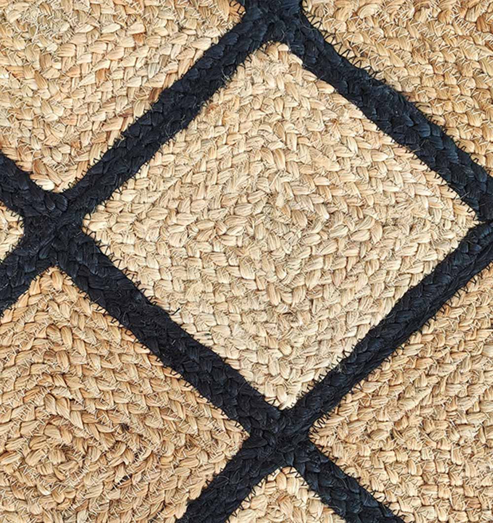 Close-up of the RAMSHA HOME Jute Rectangular Rug Natural And Black BR-034, showcasing tan woven natural fibers with braided textures and bold black borders in a geometric pattern.