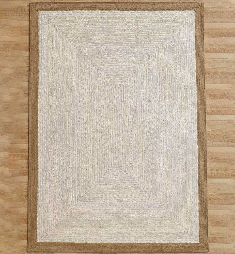 The RAMSHA HOME Decor Rectangle Jute Rug - BR 089 features a beige center with a subtle geometric woven pattern and a solid light brown border, shown on a light wood floor.