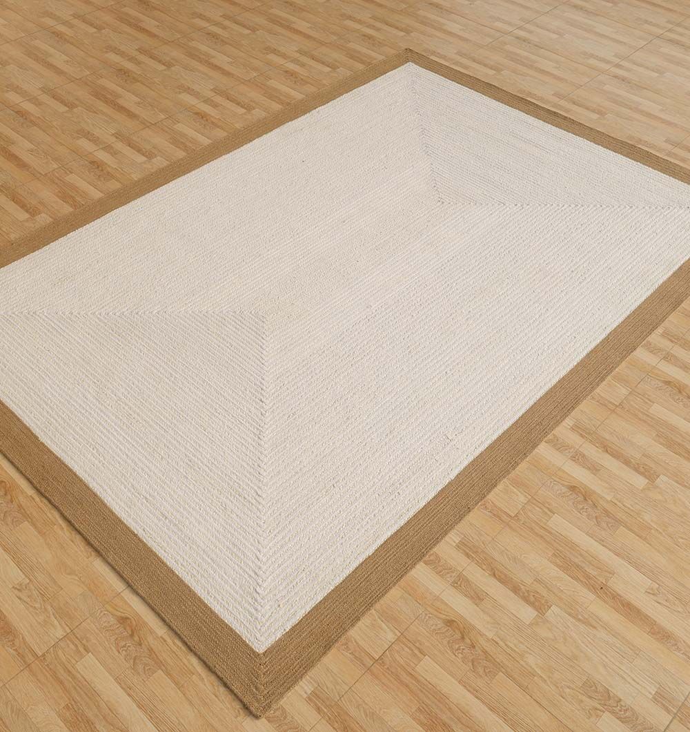The RAMSHA HOME Rectangle Jute Rug - BR 089 features a cream center with a light brown border and subtle geometric pattern, adding elegance to any room with its two-tone design on light wood-patterned floors.