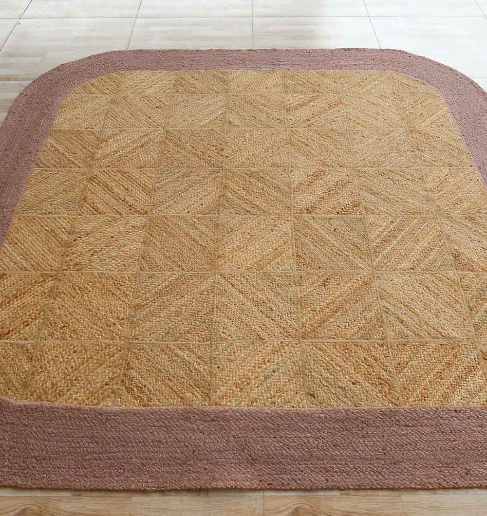 The RAMSHA HOME Natural & Rust Color Braided Outdoor Rug (BR 094) features a textured tan center with a wide, light brown border, shown here on a tiled floor.