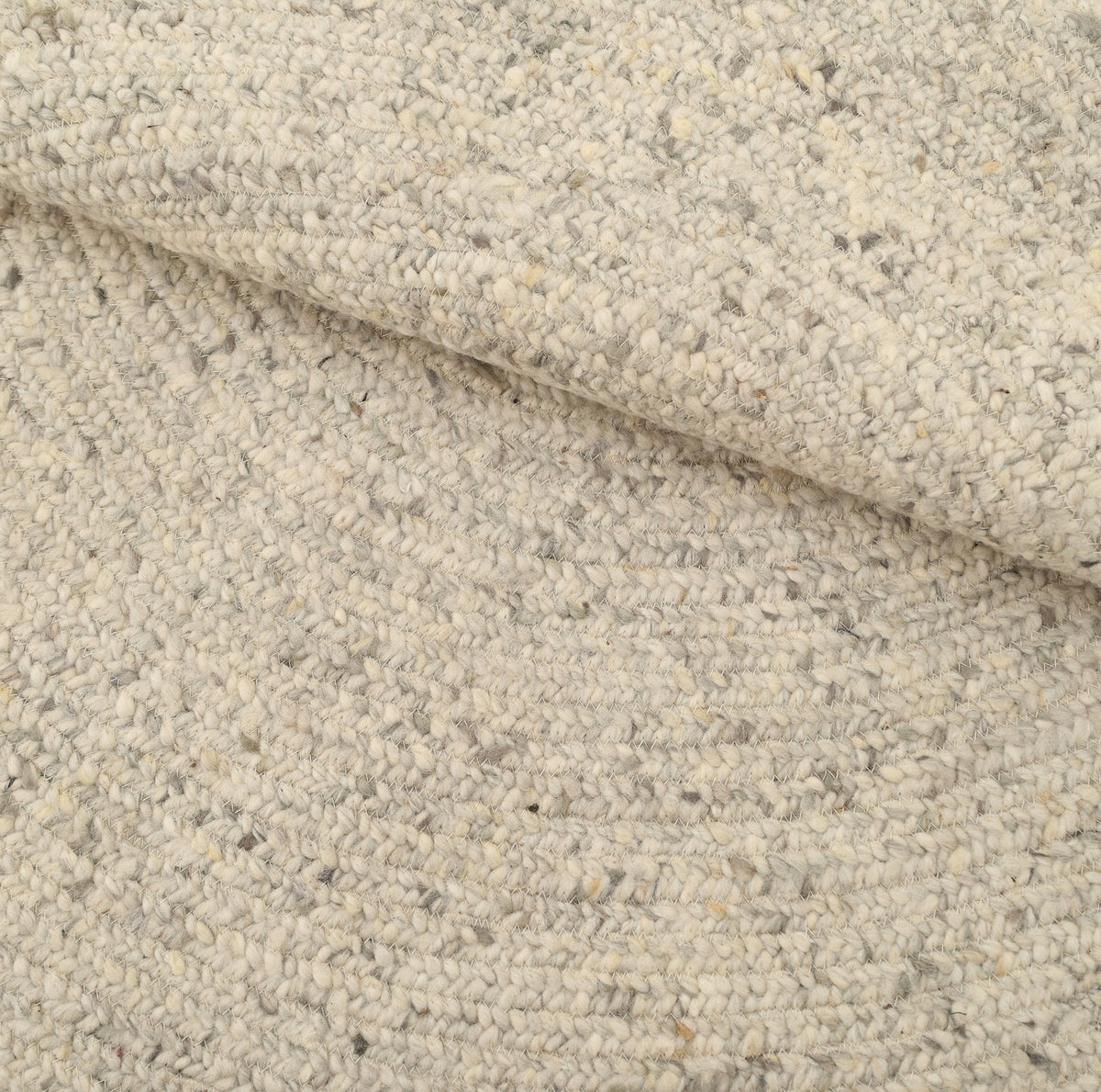 Close-up of the RAMSHA HOME Round Braided Wool Area Rug Handmade Circular Rug- BR 100 in cream and light gray, featuring a textured, braided design with a slightly folded edge that highlights its woven pattern and thick, soft wool fibers.