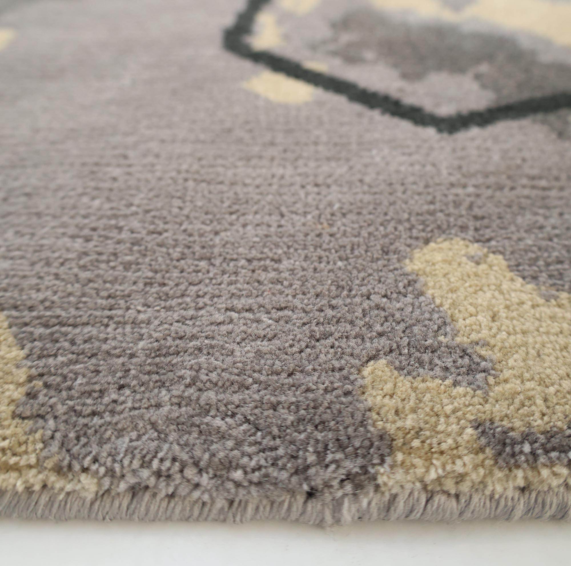 Close-up of the RAMSHA HOME Modern Geometric Round Rug Grey & Beige Rug CMN 133, highlighting its soft, plush fibers, textured surface, and low pile edge in gray and beige tones against a white background.
