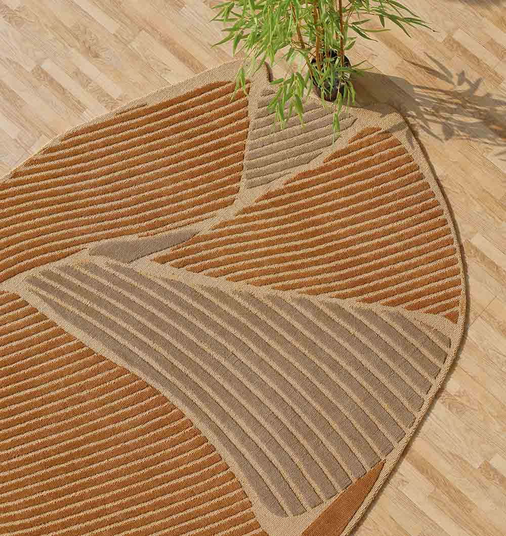 The Luxurious Multi Color Bedroom Decor Novara Rug - CMN 30 (200x300cm) by RAMSHA HOME, featuring wavy tan and brown stripes, enhances a light wood floor and is paired with a green potted plant partially visible at the top.