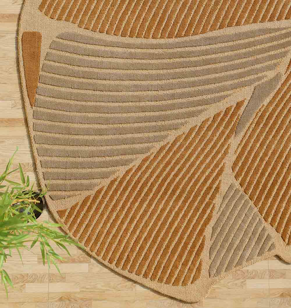 The RAMSHA HOME Luxurious Multi Color Bedroom Decor Novara Rug - CMN 30 (200x300cm), featuring abstract earth tones with raised tan, brown, and beige lines, lies on a light wooden floor. Green plant leaves appear in the lower left corner.