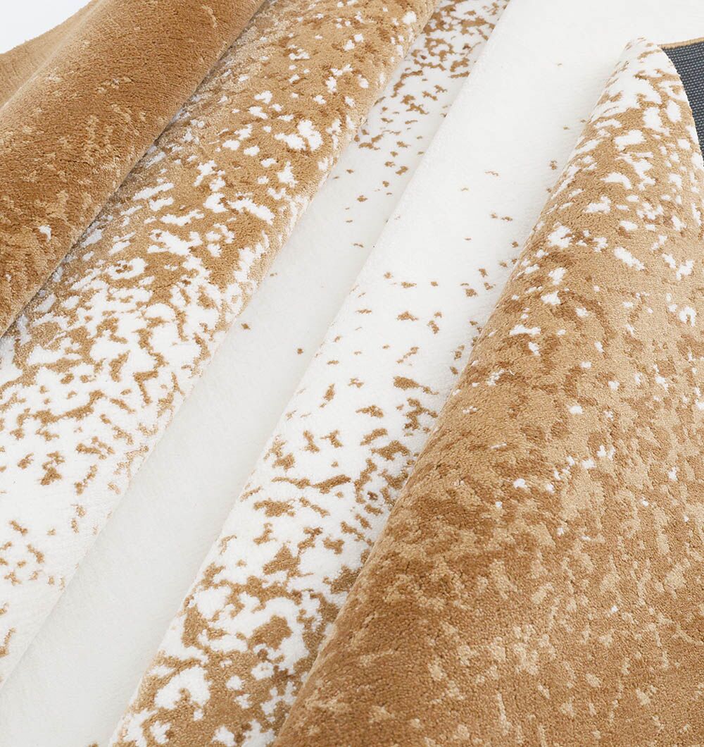 Close-up of the Rectangle Multi Color Rug - CMN 69 (200x300cm) by RAMSHA HOME, featuring tan and white speckles in diagonal overlapping layers, mimicking animal fur or a natural texture.