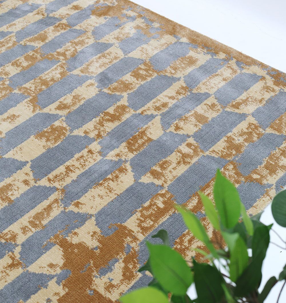 The RAMSHA HOME Home Decor Multi Color Novara Rug - CMN 82 with a geometric design covers the floor, while a green leafy plant is partly seen in the lower right corner.