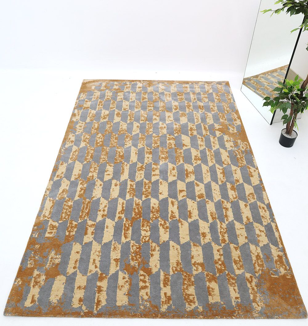 The RAMSHA HOME Novara Rug (CMN 82) is a machine-made rectangular area rug featuring a geometric pattern in gray, beige, and mustard yellow tones, ideal for modern spaces and stylishly placed on white flooring with decor accents.