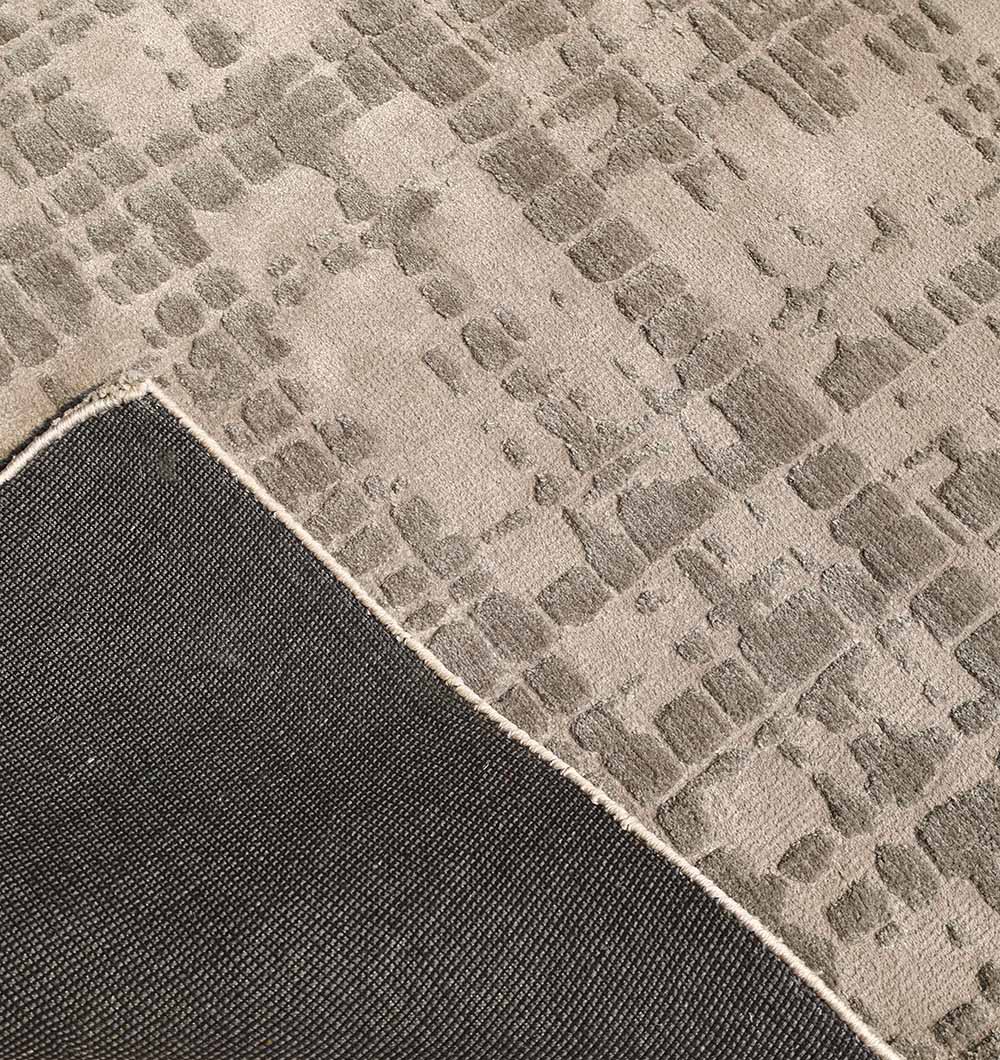 The RAMSHA HOME Indoor Decor Novara Area Rug - CMN 83 (170x240 cm) features a textured, machine-made surface with a subtle geometric pattern in gray and beige tones, plus an abstract grid design and visible dark gray underside.