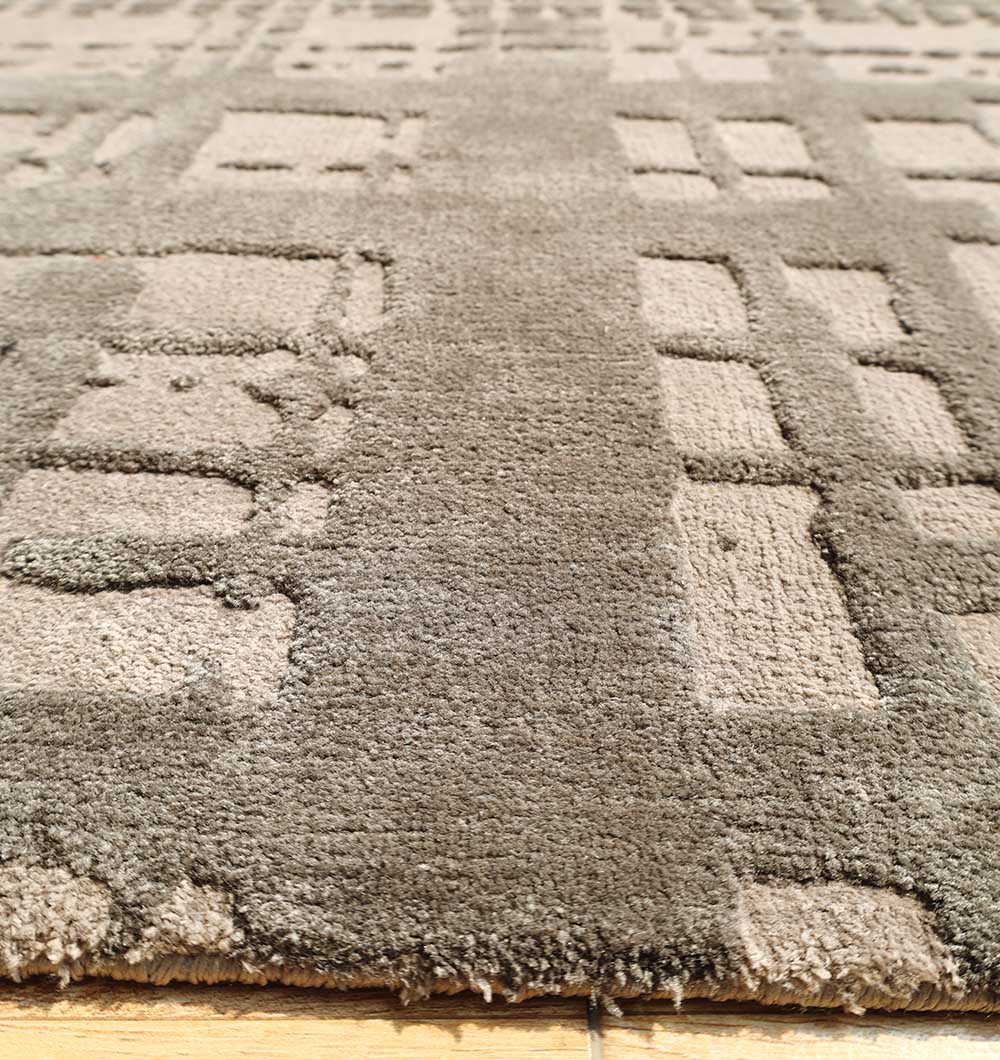 Close-up of the RAMSHA HOME Indoor Decor Novara Area Rug - CMN 83 (170x240 cm), showcasing its raised geometric pattern and textured taupe surface, machine-made and displayed on a wooden floor.