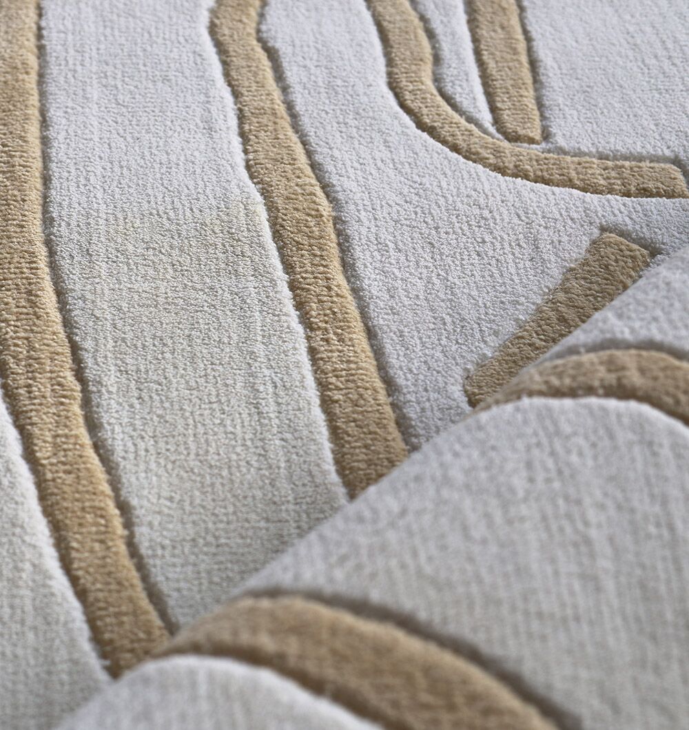 Close-up of the RAMSHA HOME White & Beige Novara Area Rug - CMN 84 (200x300 cm), featuring machine-made, raised abstract lines and curved shapes in soft beige and cream for a plush, modern look.
