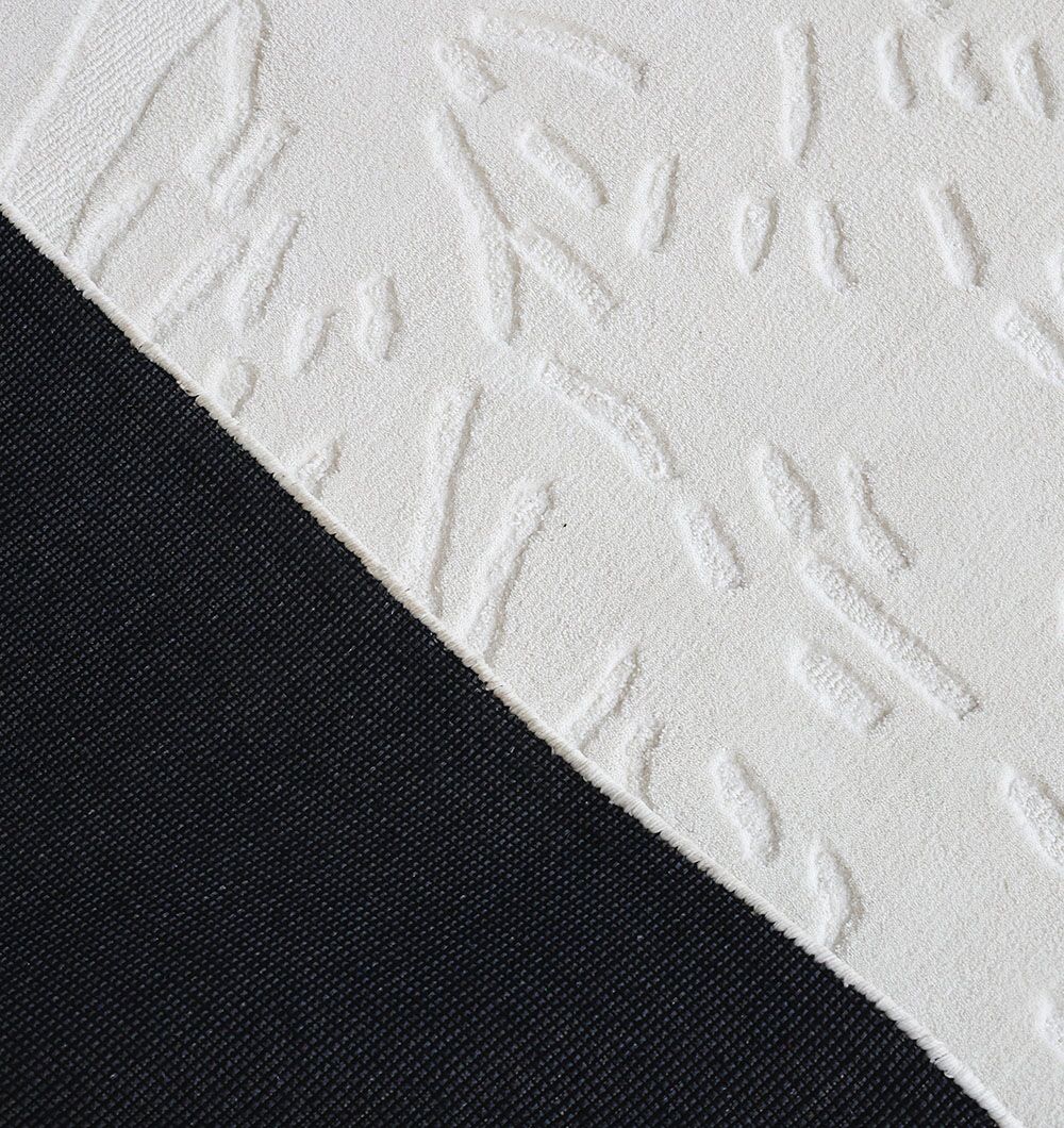 The RAMSHA HOME Rectangle Decorative Area Rug - CMN 86 (200x300 cm) features a white textured design with abstract raised patterns, diagonally contrasting with a solid black fabric for a sharp, modern look.