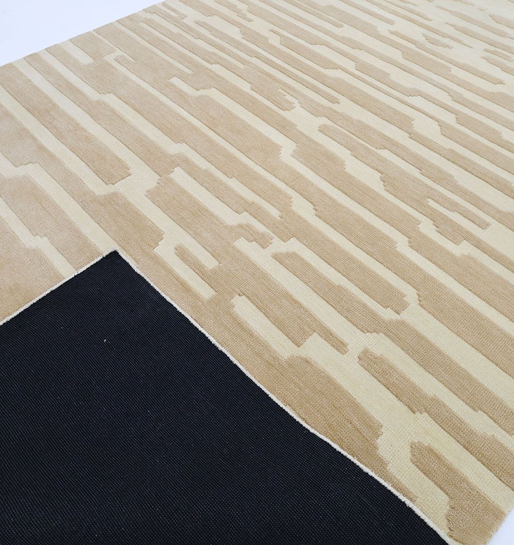 The RAMSHA HOME Dark Beige Home Decor Rug - CMN 88 (200x300 cm) features a modern abstract geometric pattern and a flipped corner reveals its black non-slip backing, emphasizing the rug's durability and stylish, contemporary machine-made design.