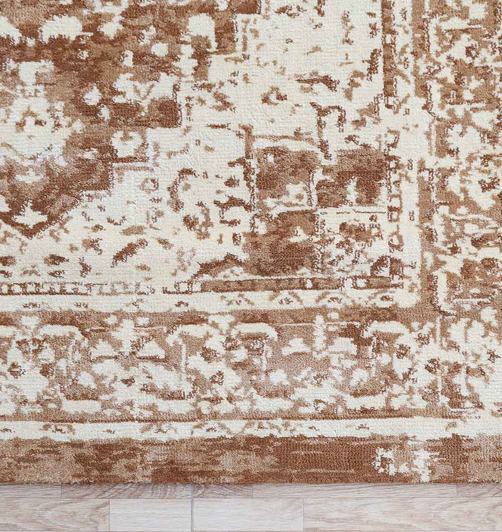 A close-up of the RAMSHA HOME Traditional Brown Medallion Novara Carpet - CMN 91 (170x240cm) shows its textured, vintage-inspired pattern with abstract shapes and faded areas on a light wooden floor.