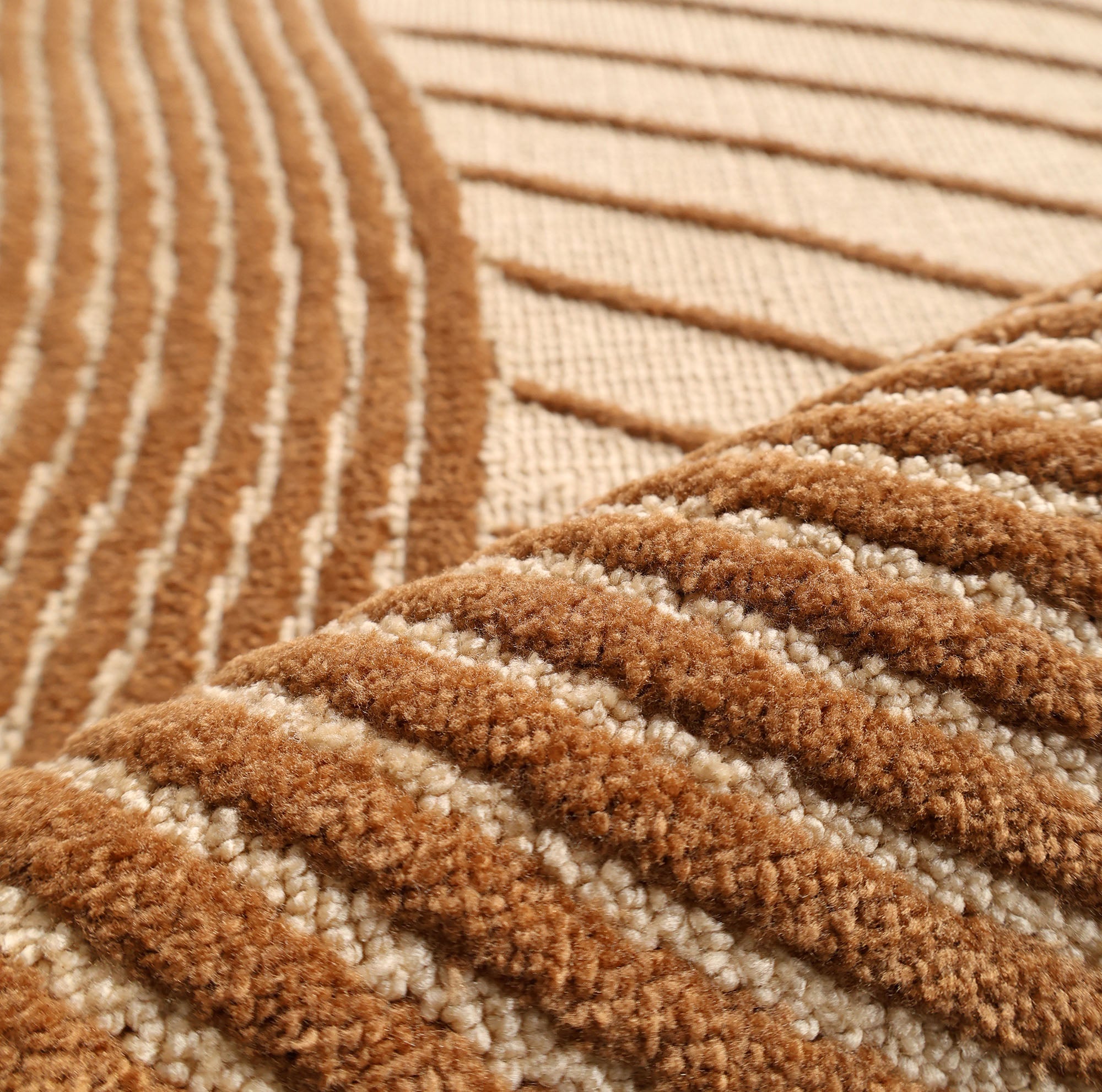 Close-up of RAMSHA HOME's Layered Wave Modern Round Abstract Rug CMN 106, featuring plush fibers and raised, wavy brown and beige stripes. Its textured geometric patterns add depth and contemporary style to any space.