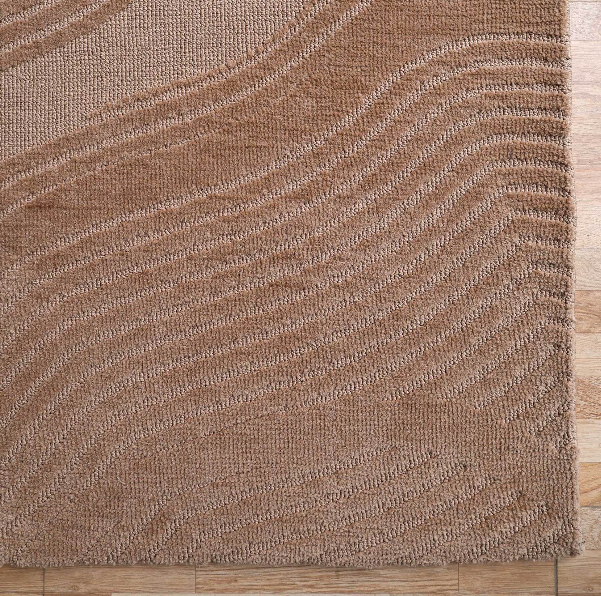 A close-up of the RAMSHA HOME Terrain Design 200x300 CM Rectangle Shaped Rug CMN 112, featuring a brown textured surface with wavy, raised patterns, displayed on a wooden floor.