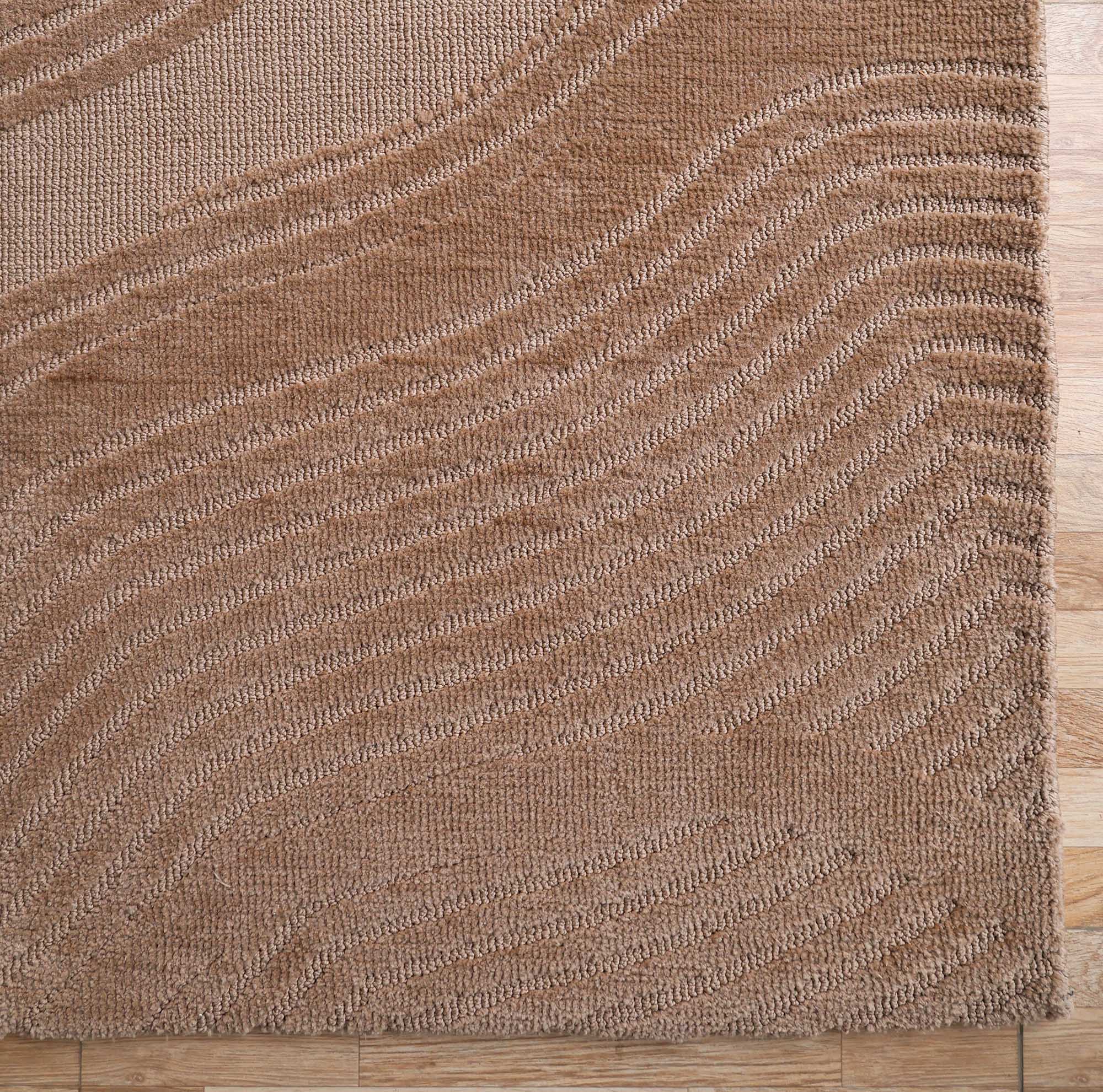 A close-up of the RAMSHA HOME Terrain Design 200x300 CM Rectangle Shaped Rug CMN 112, featuring a brown textured surface with wavy, raised patterns, displayed on a wooden floor.