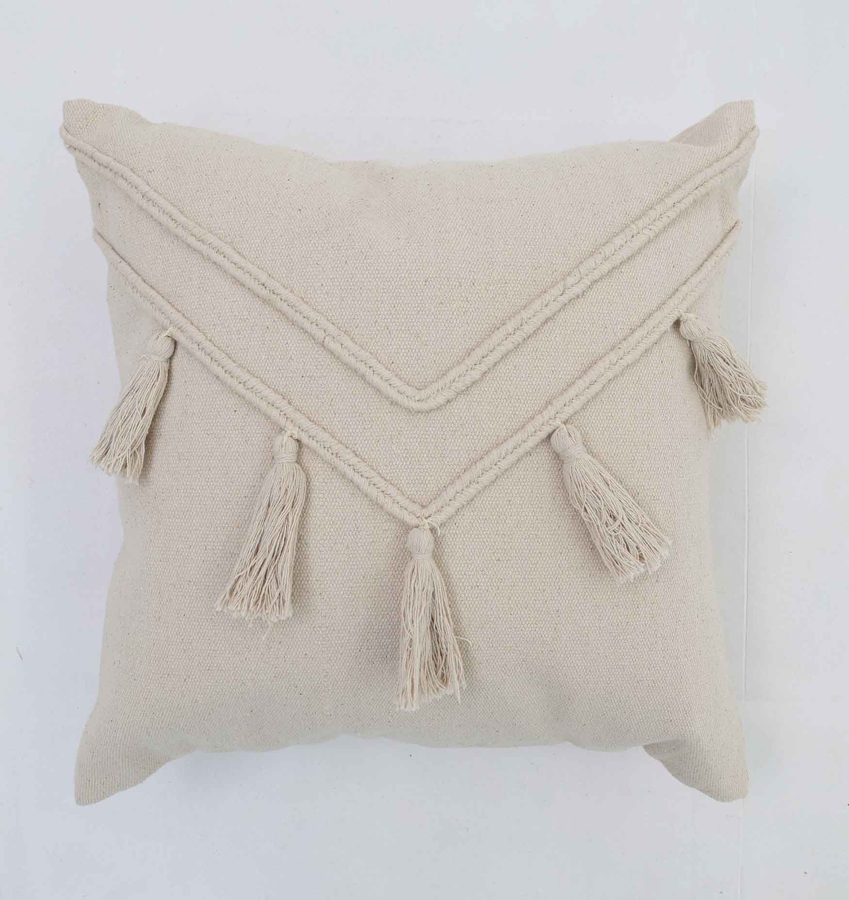 The Ramsha Home CS 294 cushion (45x45cm) features a natural beige hue, textured chevron pattern with five tassels, adding stylish flair to your decor. Shown against a white background. Luxury Rugs & Home Furnishings Brand in the UAE.