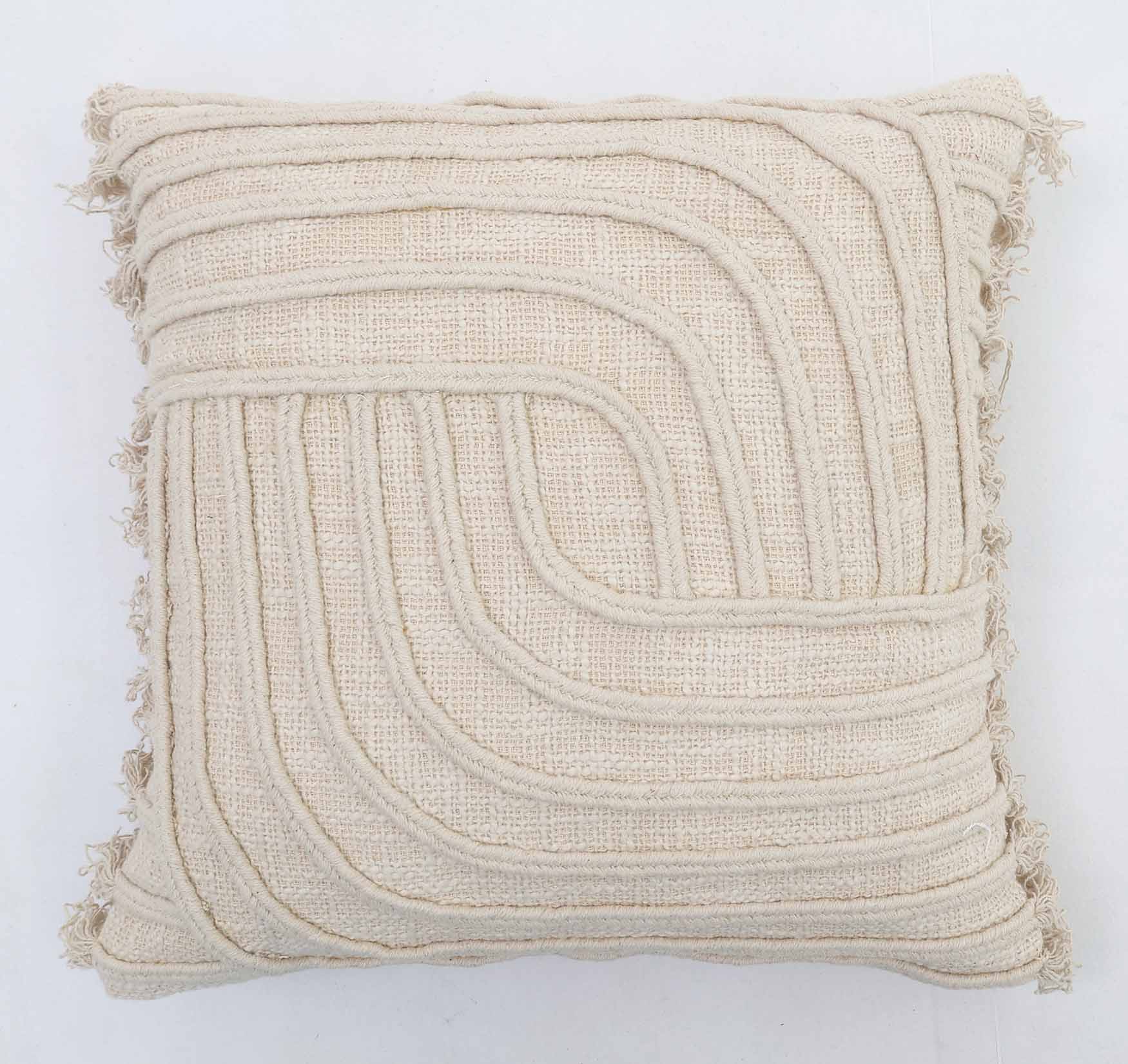 The Natural Color Cushion - CS 295 (45x45cm) by Ramsha Home features cream tones, a textured geometric design with raised curved lines, and short frayed tassels along the edges. Perfect for elegant decor from a luxury UAE brand.