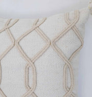 Close-up of the Home Decor Tassel Cushion (Natural & White, 45x45cm) by Ramsha Home. Featuring raised geometric rope patterns, only the top corner of this stylish cushion is visible against a plain white background.