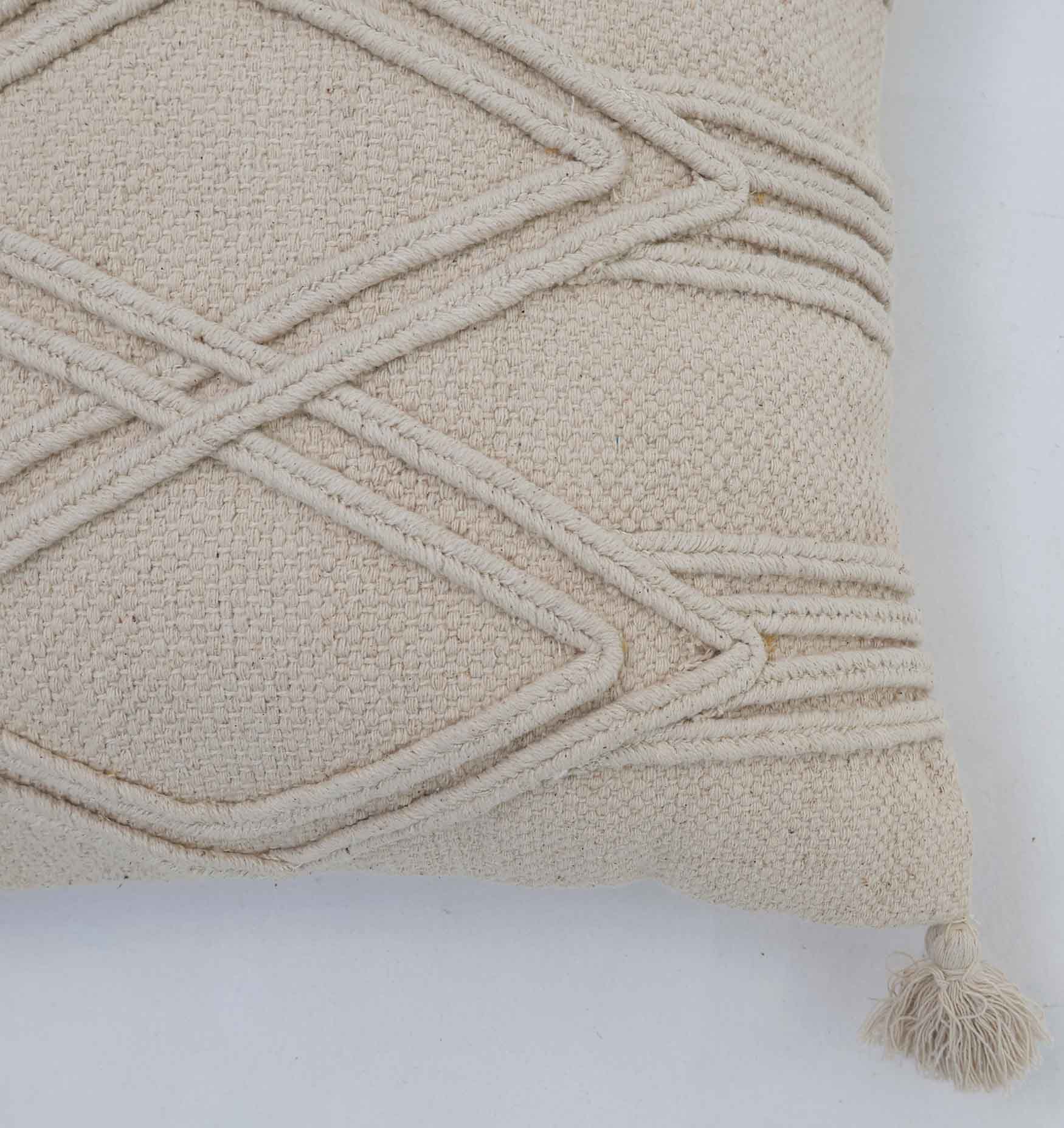 Close-up of Ramsha Home's Home Decor Tassel Cushion Natural Color - CS 304 (45x45cm), showcasing raised diamond patterns, horizontal lines, and a tassel accent in the corner—a stylish addition against a plain background.