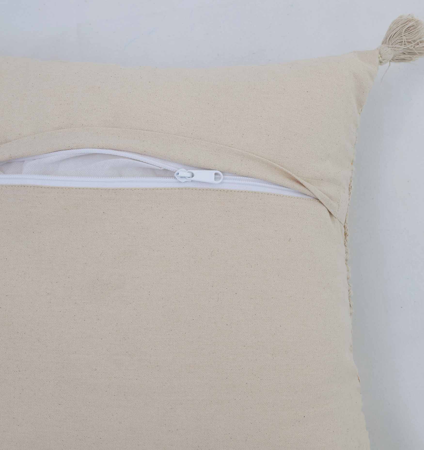 A close-up of the Ramsha Home Decor Tassel Cushion Natural Color - CS 304 (45x45cm) shows its tassel detail and partially open white zipper revealing the lining, set against a plain white background. From Ramsha Home: Luxury Rugs & Home Furnishings Brand In The UAE.