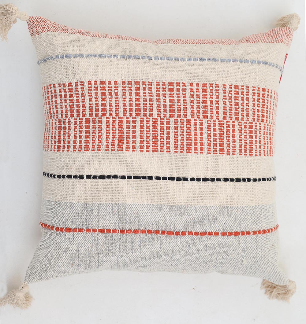 The Multi Color Home Decor Cushion - CS 314 B by Ramsha Home features woven red, black, and gray stripes on cream cotton, with tasselled corners and a boho textured design—perfect for adding style to any sofa.