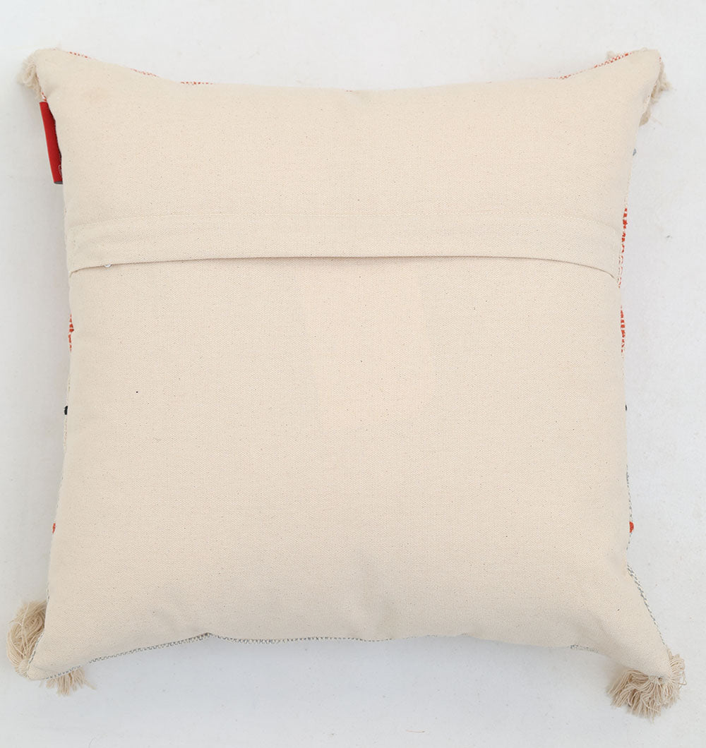 The Multi Color Home Decor Cushion (CS 314 B) from Ramsha Home, a luxury home furnishings brand in the UAE, features tassels at the corners and a flap-style back, shown here on a plain white surface.