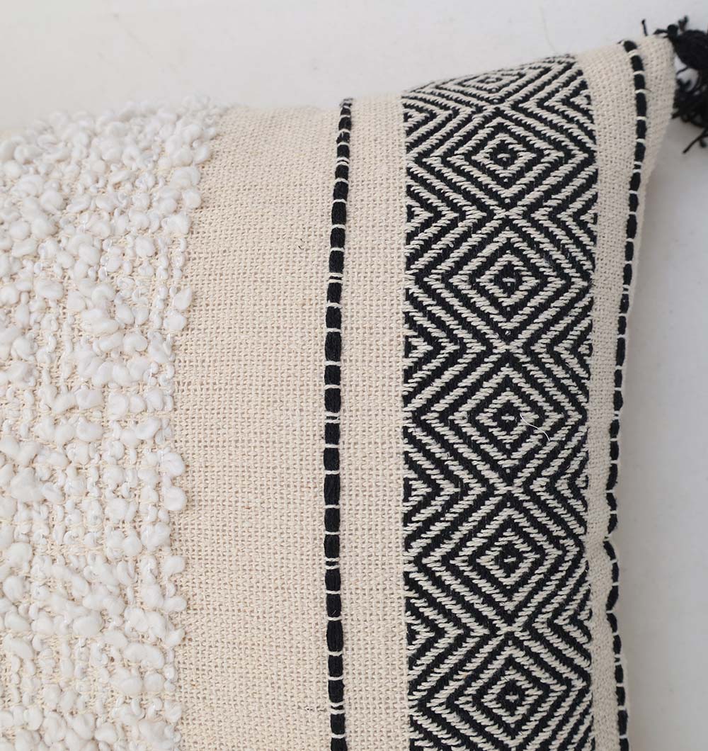 A close-up of the Multi Color Home Decor Cushion - CS 314 C by Ramsha Home shows beige cotton, tufted weaving on the left, and a black and white geometric diamond pattern on the right—perfect for stylish color blocking.