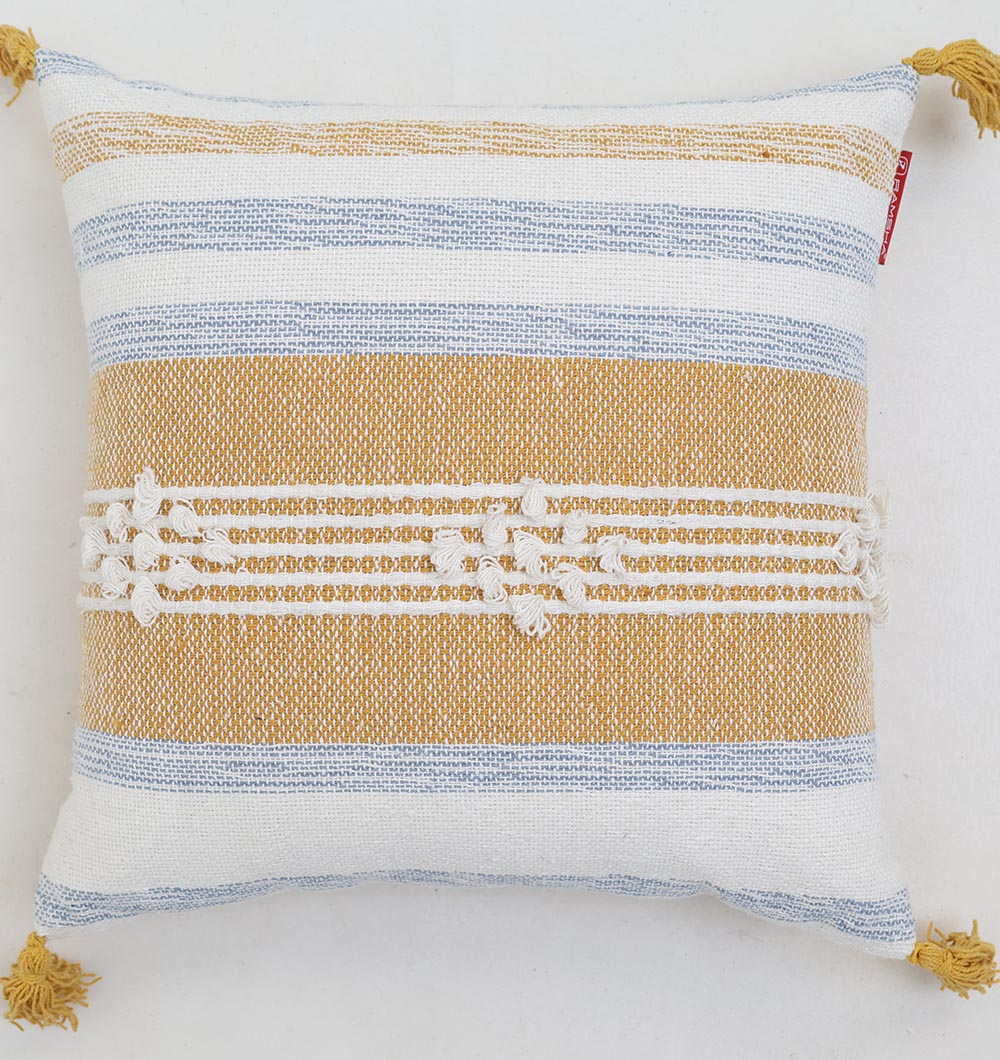 The Multi Color Home Decor Cushion - CS 315 A from Ramsha Home features horizontal mustard yellow, blue, and white stripes with a woven texture, central white stitching, and yellow tassels on each corner. Perfect for stylish accents in your home.
