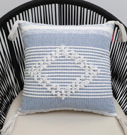The Multi Color Home Decor Cushion - CS 315 B from Ramsha Home features textured embroidery and tassels, shown on a black rope-back chair.