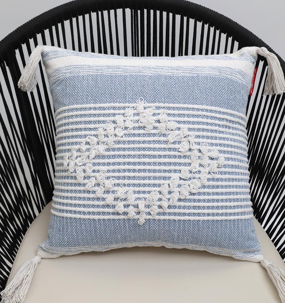 The Multi Color Home Decor Cushion - CS 315 B from Ramsha Home features textured embroidery and tassels, shown on a black rope-back chair.