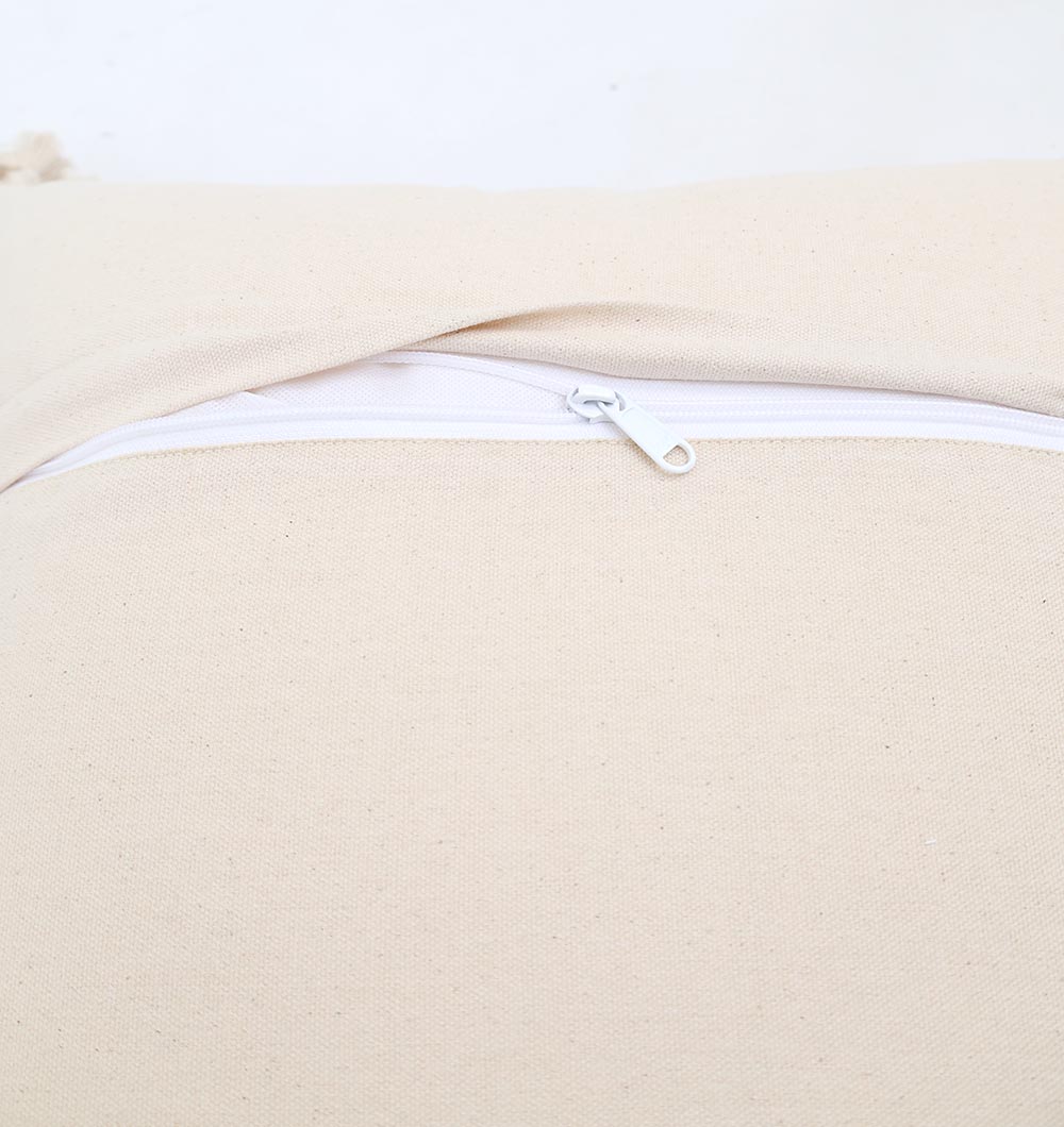 A close-up of the Ramsha Home Cream & Brown Printed Cotton Cushion 45x45 cm (CS 318) shows its textured fabric and partially closed white zipper, set against a plain light background.