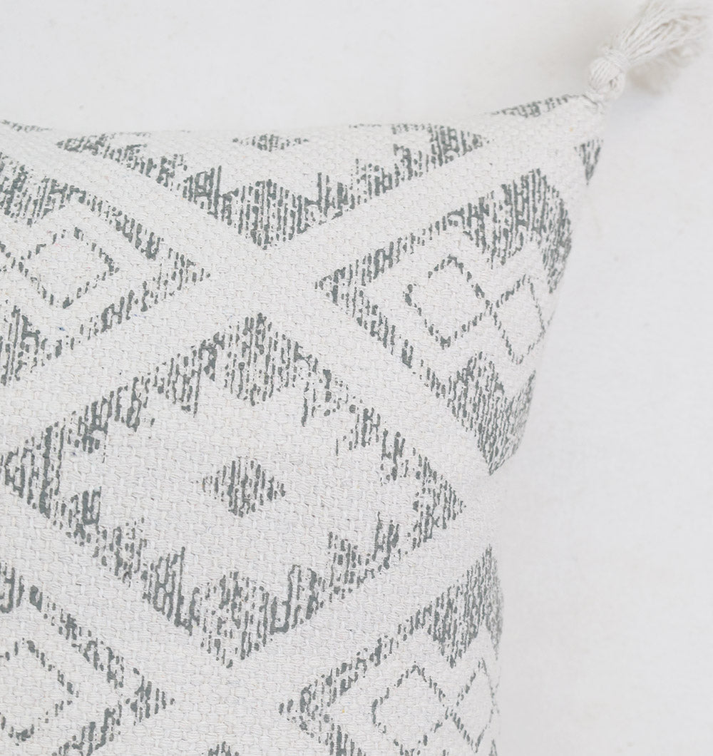 Close-up of the Ramsha Home White and Grey Printed Cotton Cushion 45x45 cm (CS 319), featuring a textured geometric diamond pattern and a tassel on one corner for added charm. Perfect for enhancing your home décor in the UAE.