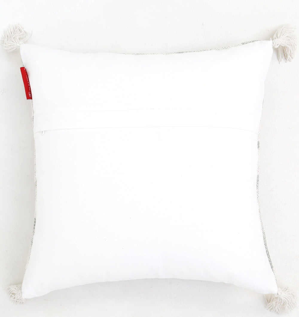 The Ramsha Home White and Grey Printed Cotton Cushion 45x45 cm CS 321 features a square shape with corner tassels and a red tag, displayed on a plain white background.