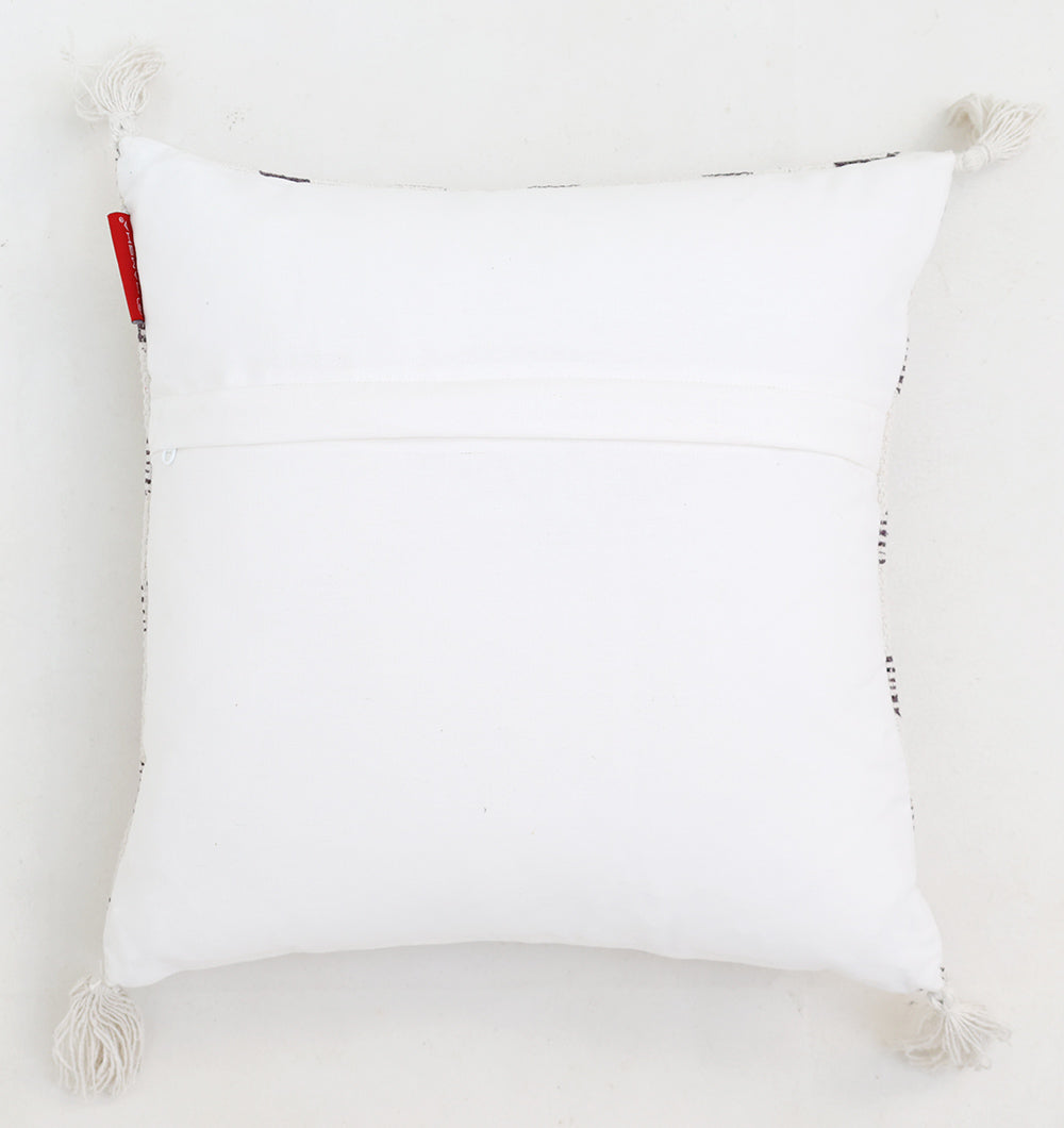 The Ramsha Home White and Grey Printed Cotton Cushion 45x45 cm (CS 322) features a stylish square design with decorative tassels at each corner, a small red tag on one side, and is shown against a white background.