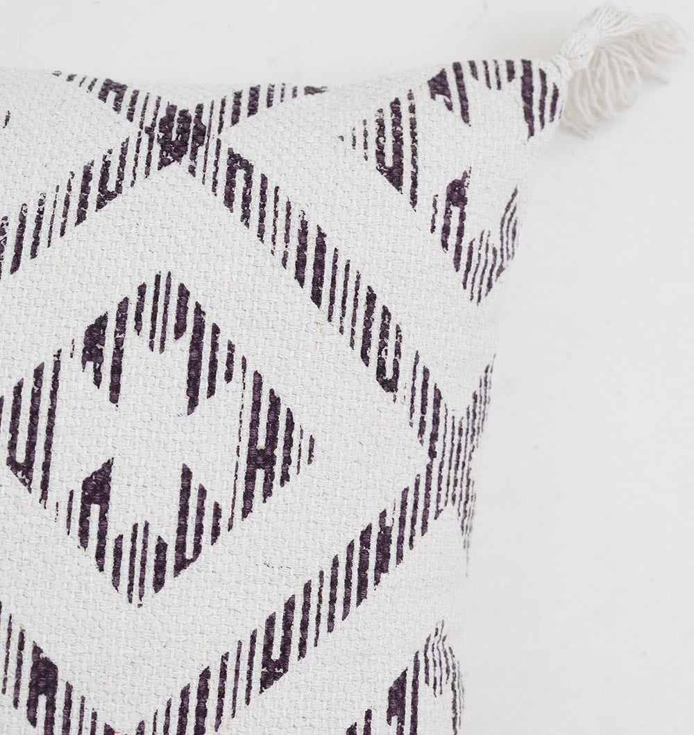 Close-up of the Ramsha Home White and Grey Printed Cotton Cushion 45x45 cm (CS 322), featuring a black geometric diamond pattern and corner tassel, set against a plain white background.
