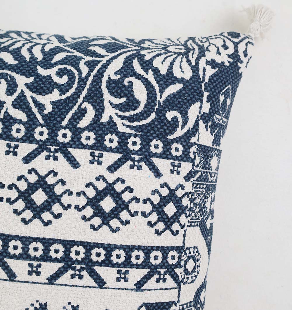 Close-up of the Ramsha Home White and Blue Printed Cotton Cushion 45x45 cm (CS 323), featuring a geometric and floral embroidered pattern with a decorative tassel. The plain white background highlights its premium, intricate details.