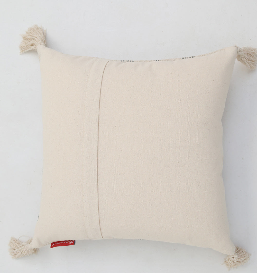 The Cream and Grey Printed Cotton Cushion 45x45 cm CS 326 by Ramsha Home features a decorative design with a plain cover, four tassels at each corner, and a small red tag, shown on a white surface.