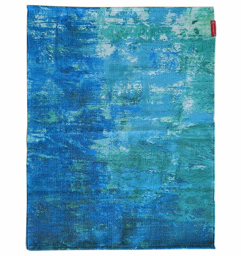 The RAMSHA HOME Gradient Printed Durry Multi Color DD-012 features abstract brushstroke-style patterns in blue, teal, and turquoise shades with a small red tag in the upper right corner, creating a modern, artistic look.