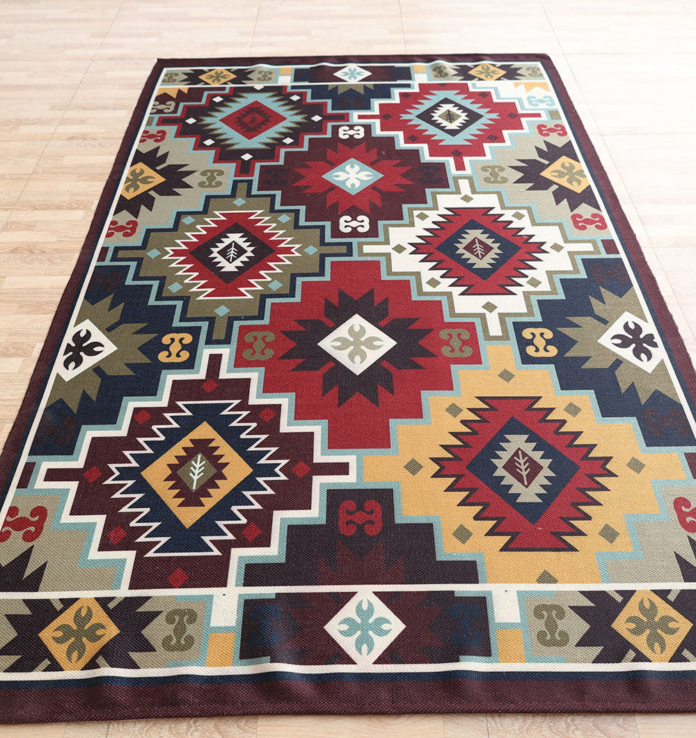 The RAMSHA HOME Tribal Digital Printed Rug – Colorful Geometric Area Rug for Living Room DD-045 features bold geometric and diamond motifs in red, blue, yellow, green, black, and white with a decorative border, displayed on a wooden floor.